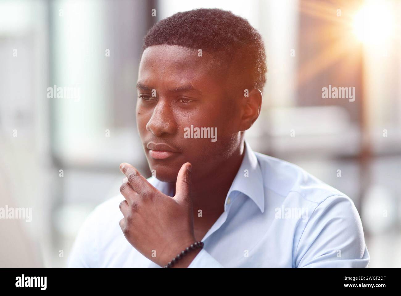Thoughtful black man in eyeglasses stack with hard task, looking at computer screen, thinking of problem solution Stock Photo
