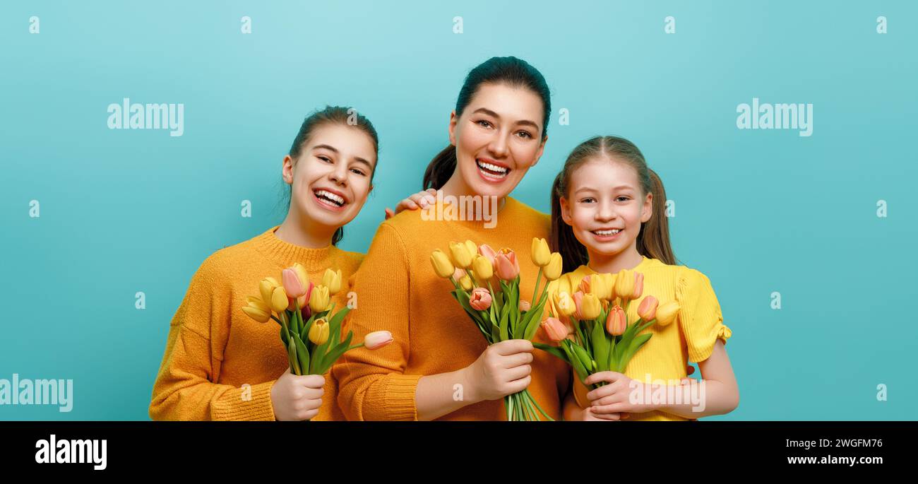 Happy day. Children daughters are congratulating mother. Family holiday and togetherness. Concept of International Women's Day. Stock Photo