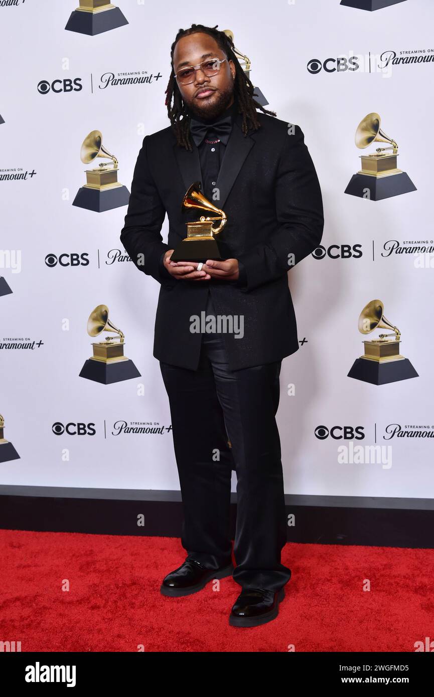 Leon Thomas poses in the press room with the award for best R&B song, a category he may be nominated in again