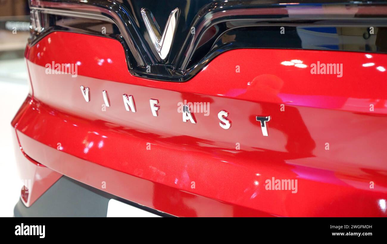 Crowds looking at new car models at Auto show. Vinfast car on display