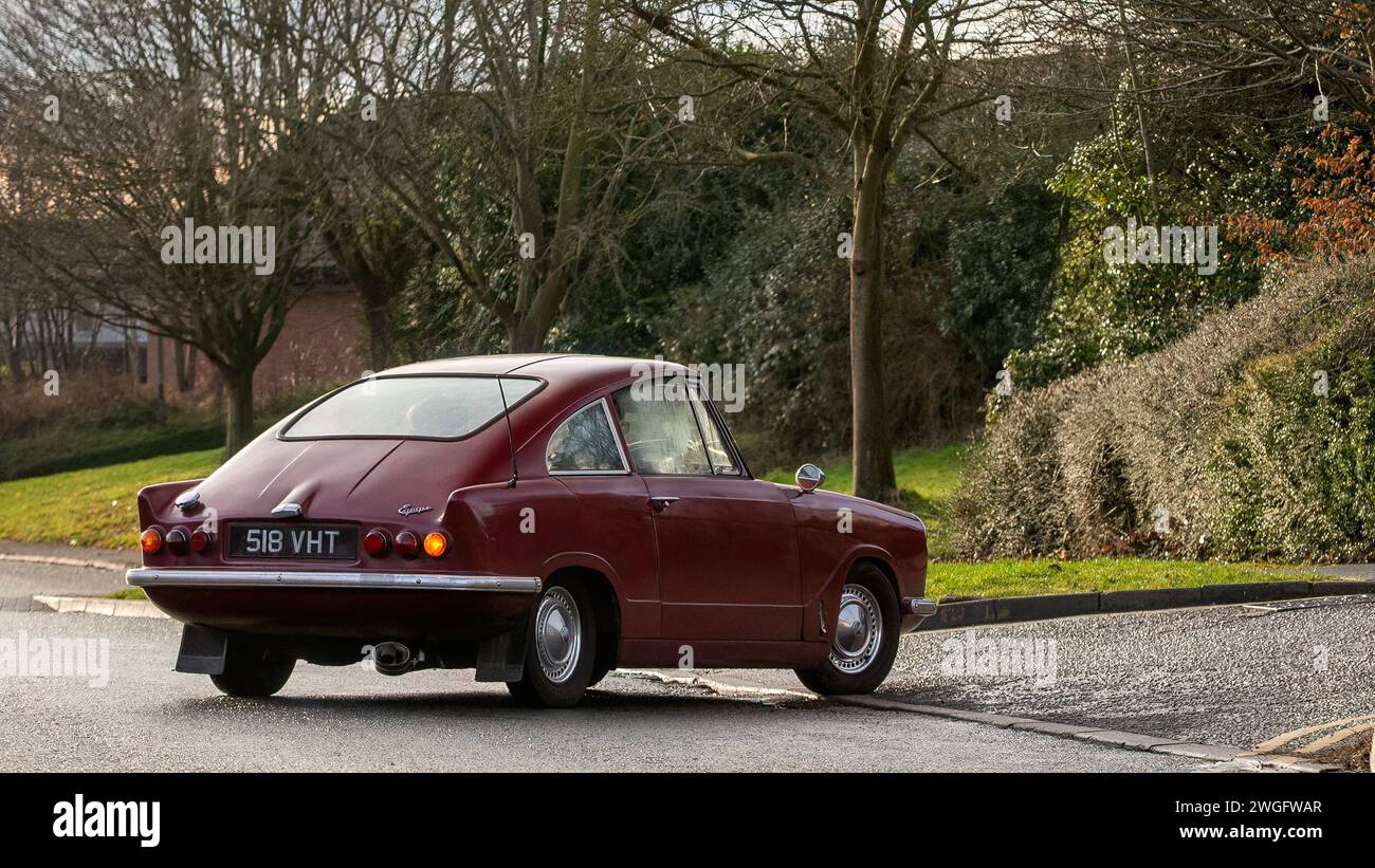 Milton Keynes,UK-Feb 4th 2024: 1964 red Bond Equipe  classic car  driving on an English road. Stock Photo