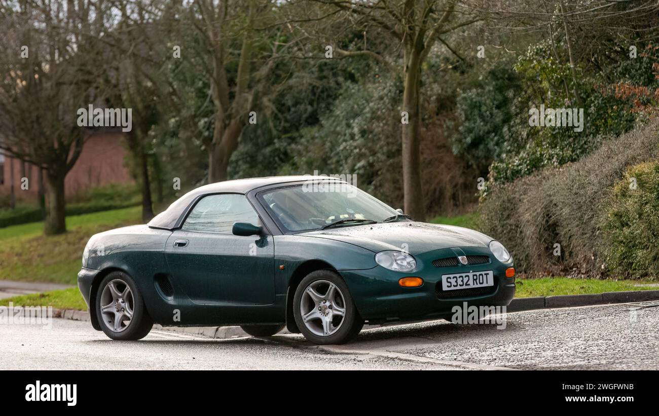 Milton Keynes,UK-Feb 4th 2024: 1998 green MG MGF  classic car  driving on an English road. Stock Photo
