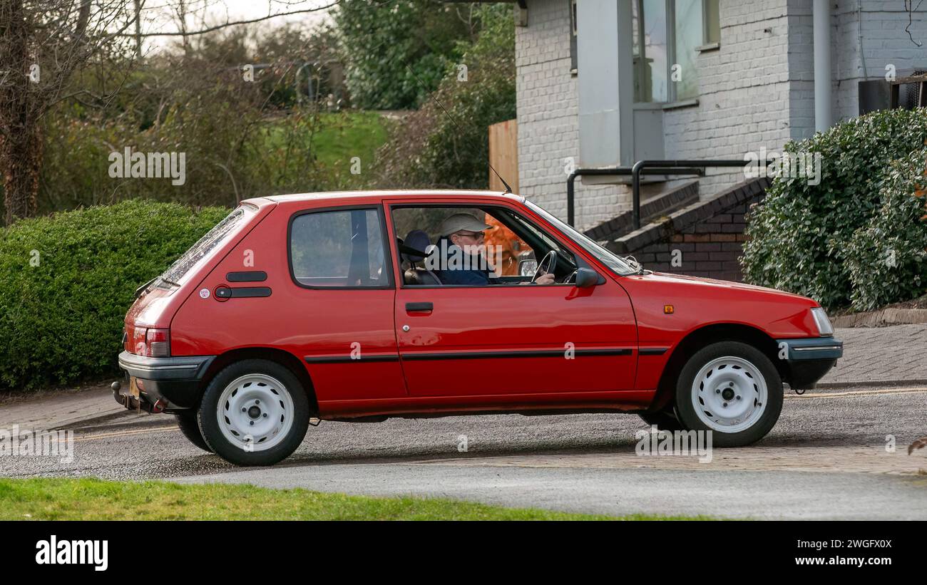 Milton Keynes,UK-Feb 4th 2024: 1996 red Peugeot 205 diesel engine  classic car  driving on an English road. Stock Photo