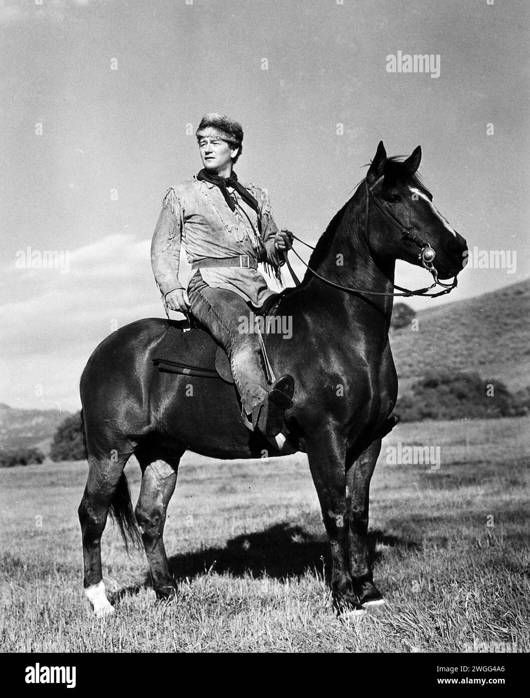 John Wayne on a horse, publicity photo 1940s, western outfit Stock Photo