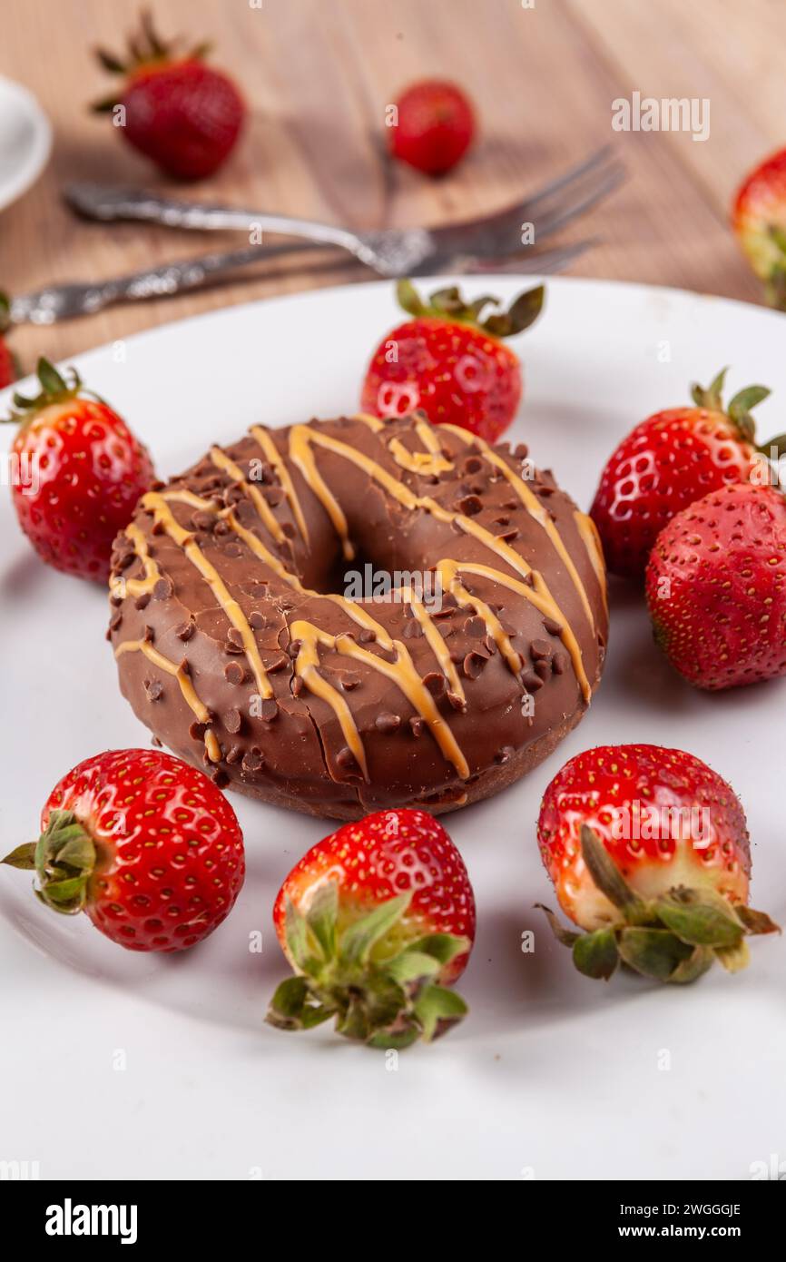 Decorative eye-catcher: chocolate donut with strawberries as an eye-catcher on any cake buffet Stock Photo