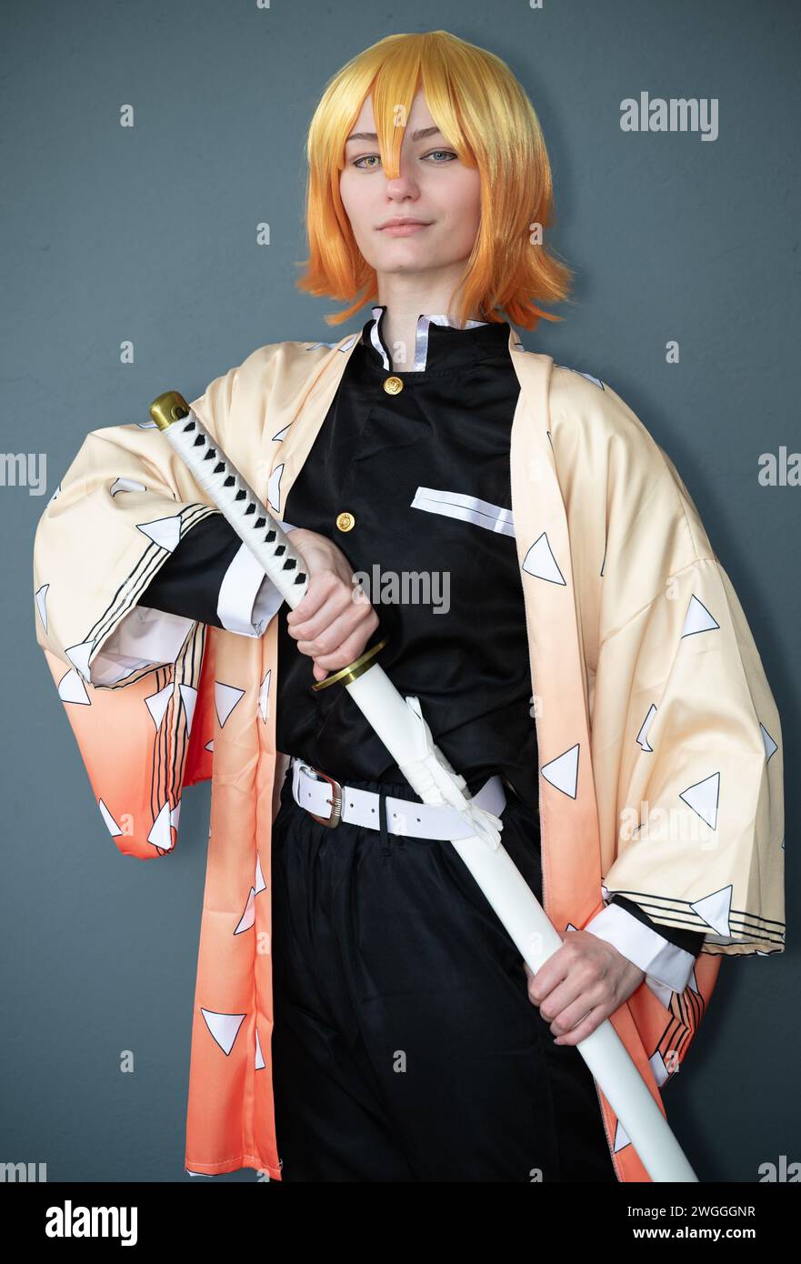 A cosplayer dressed as a samurai with orange hair Stock Photo