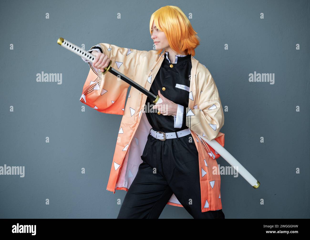 A cosplayer dressed as a samurai with orange hair Stock Photo