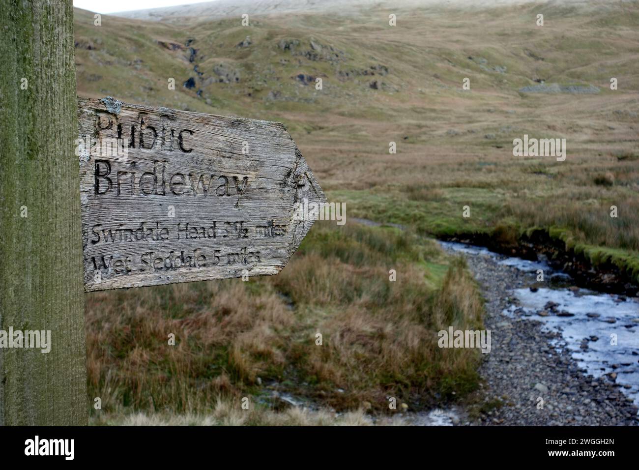 Wooden Signpost for Public Bridleway to Swindale Head & Wet Sleddale from the Gatesgarth Pass in Longsleddale, Lake District National Park, Cumbria. Stock Photo