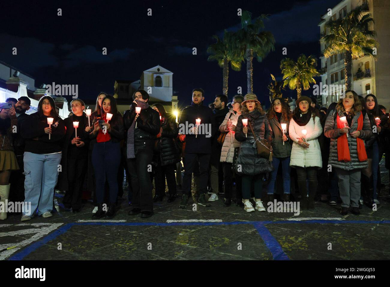 People during a torchlight procession for the International Day for the