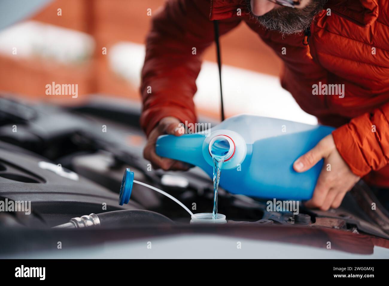 Mechanic pouring water tank hi-res stock photography and images - Alamy