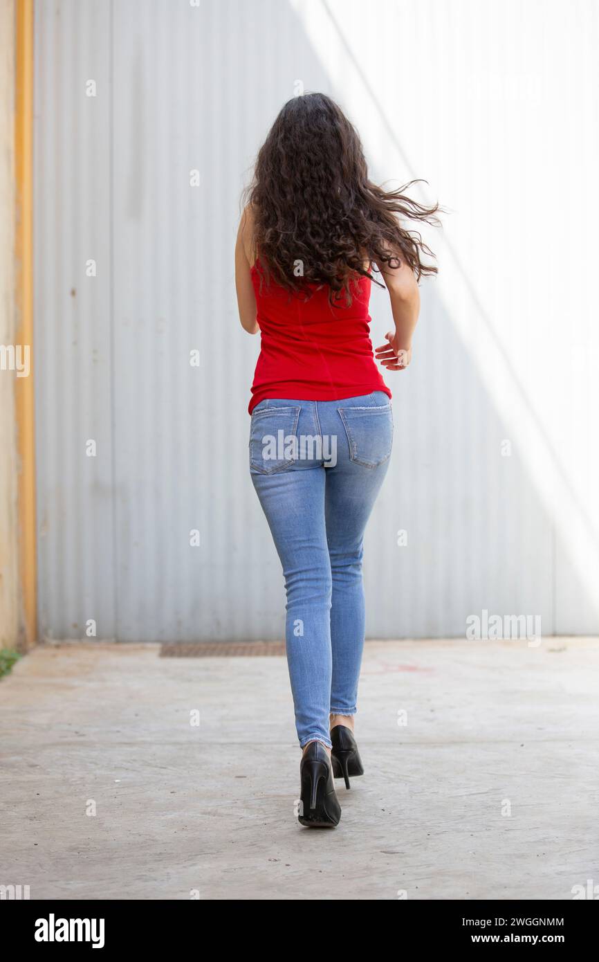 Rear view of young woman rushing away hi-res stock photography and ...