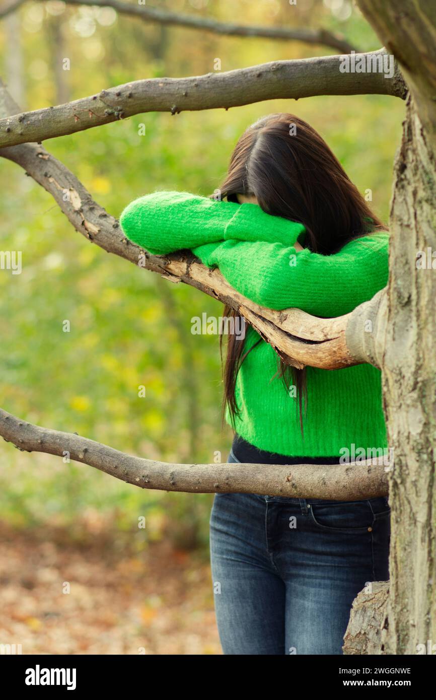 Sad woman crying by the tree Stock Photo