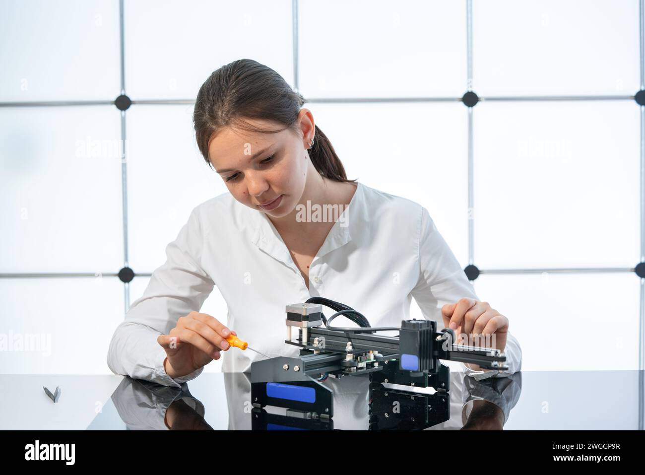 Scientific Technician Conducting Digital Research Experiment in Laboratory Stock Photo