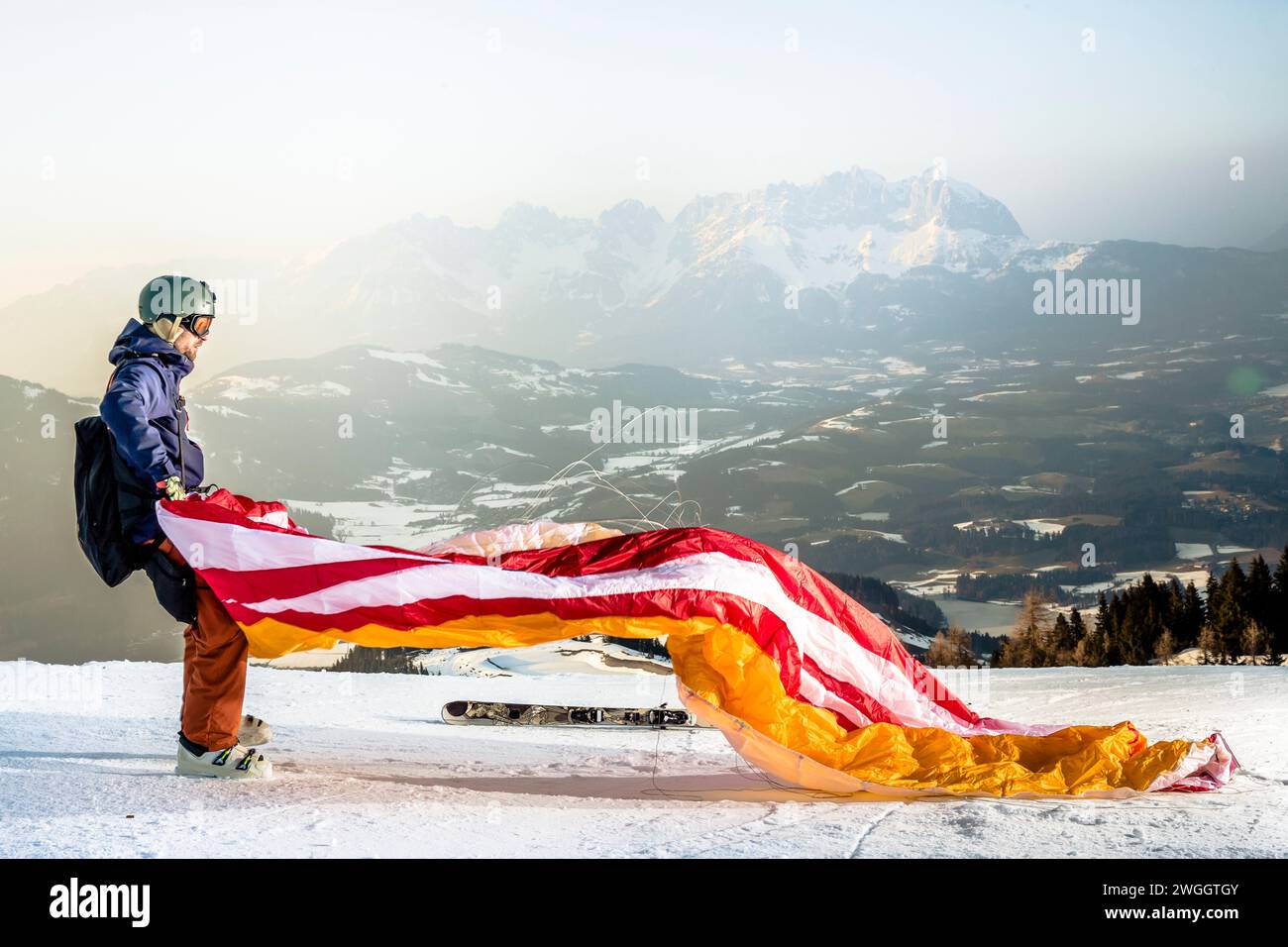 Man unfurls parachute while preparing for speed flying in Austrian Alps, Kitzbuhel, Tyrol, Austria Stock Photo