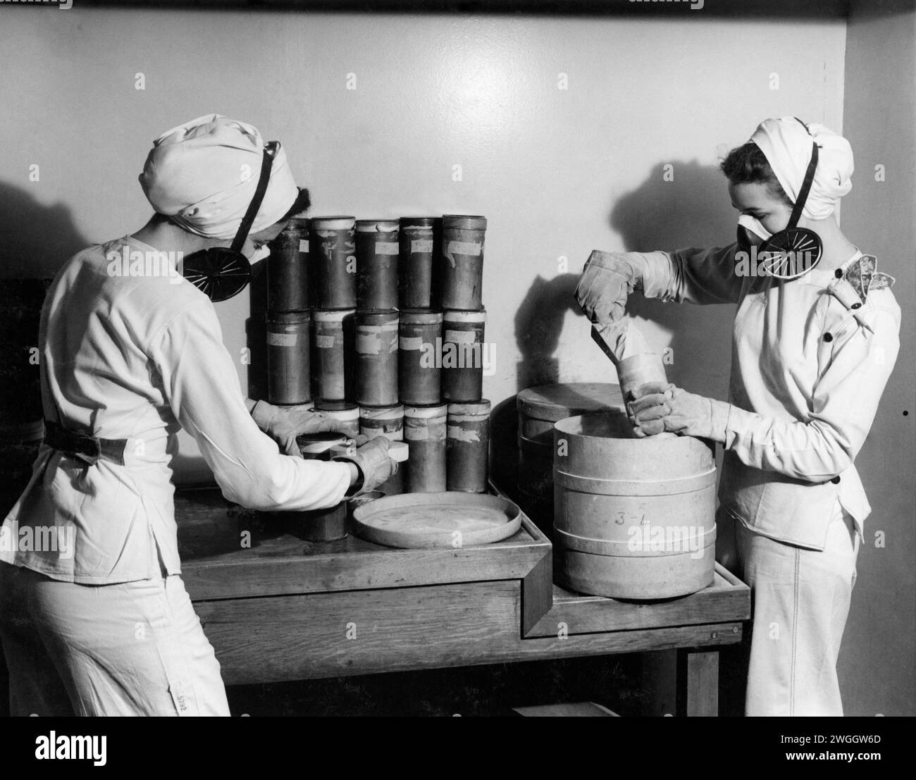 Women in safety equipment packing material for ammunition at General Engineering Company (Canada) munitions factory during the Second World War in Scarborough, Ontario circa 1943 Stock Photo