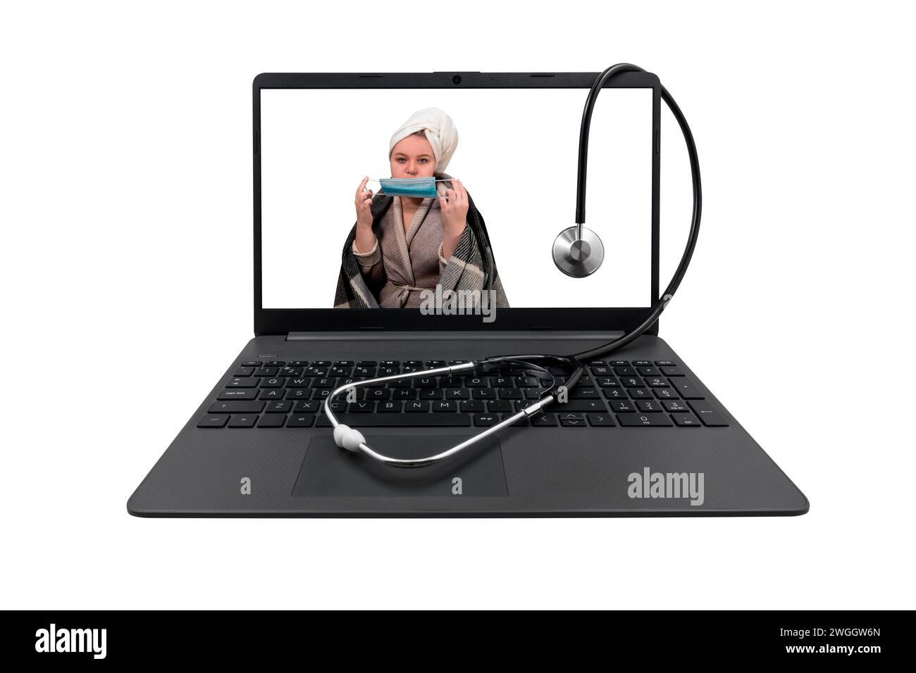 Laptop and medical stethoscope isolated on white background. On laptop screen - a girl with cold symptoms puts a protective medical mask on her face Stock Photo