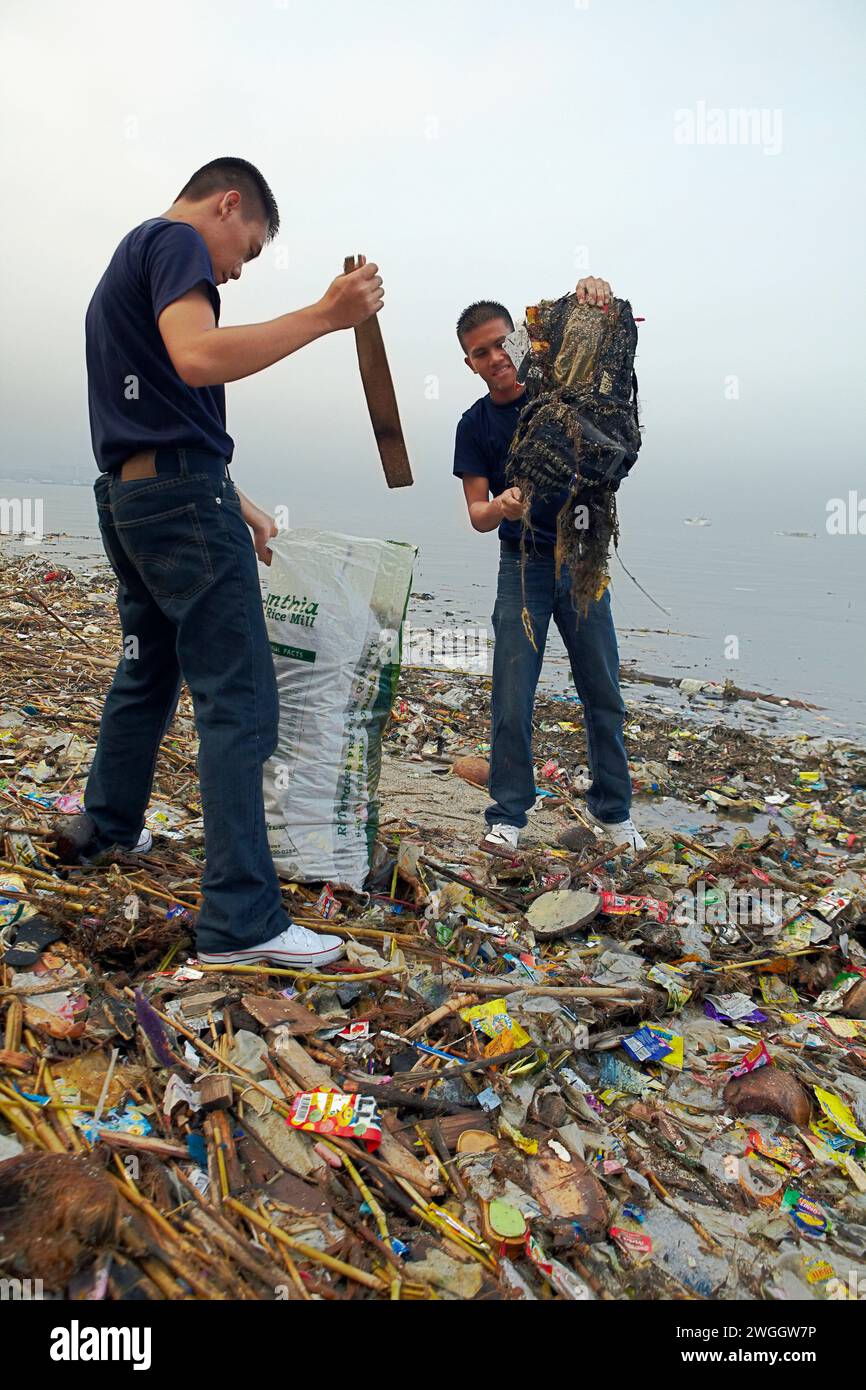 The Coast Guard helps pick up trash at the International Ocean Conservancy beach clean up at Manila Bay, Philippines. Stock Photo