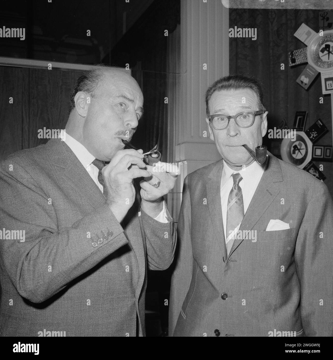 November 2, 1966. Amsterdam, Netherlands.  The Belgian author Georges Simenon (right) in Amsterdam, meeting Dutch actor Jan Teulings (left) at the statue of Maigret in the Amstel hotel. Jan Teulings was the Dutch personification of Inspector Maigret in the television series of the same name. Stock Photo