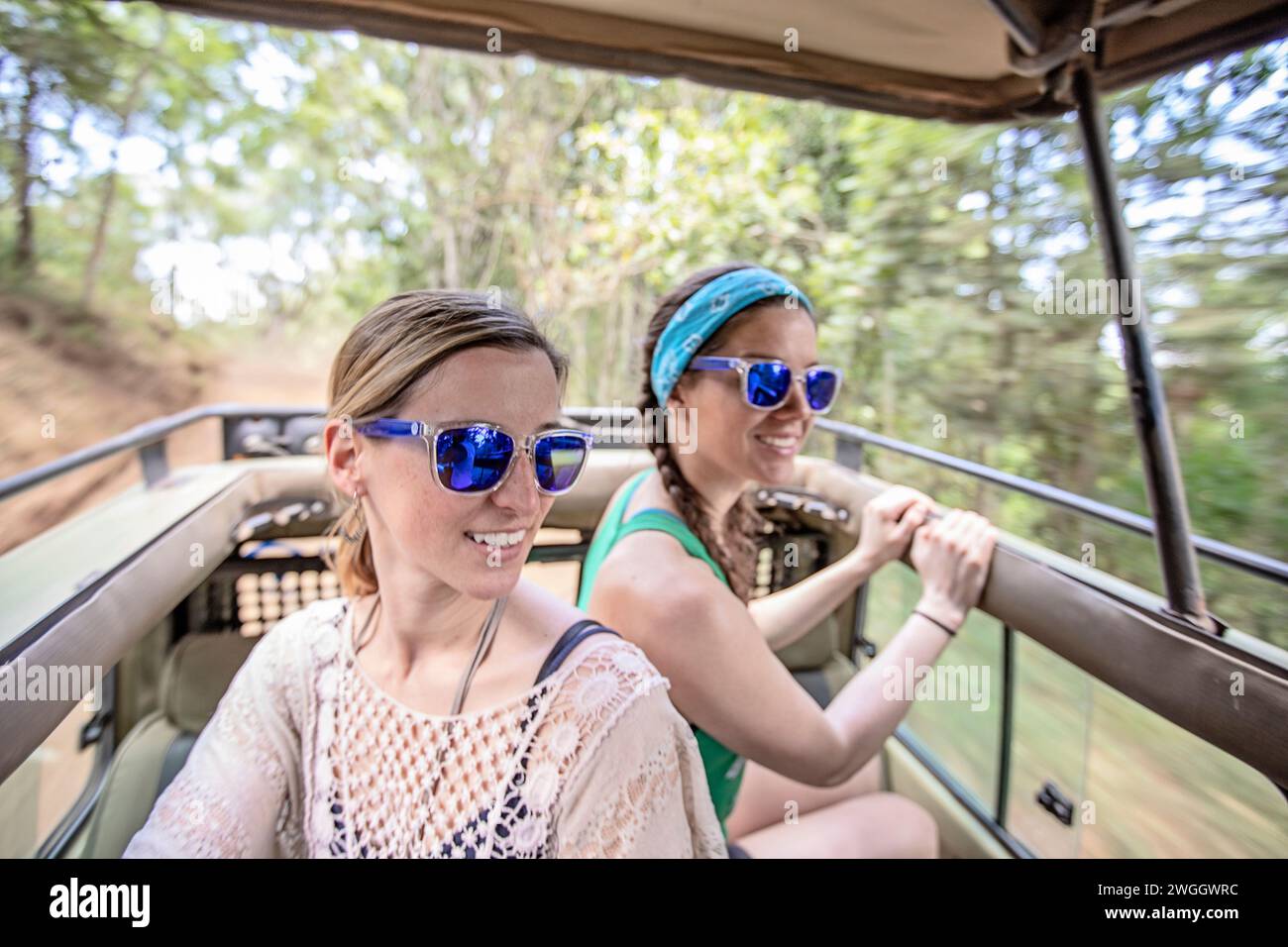 Two women in car during safari, Arusha National Park, Tanzania Stock Photo