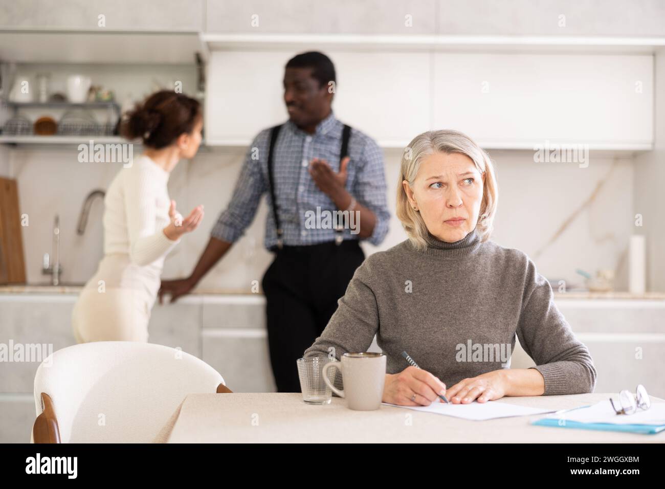 Couple discussing testament with elderly woman Stock Photo