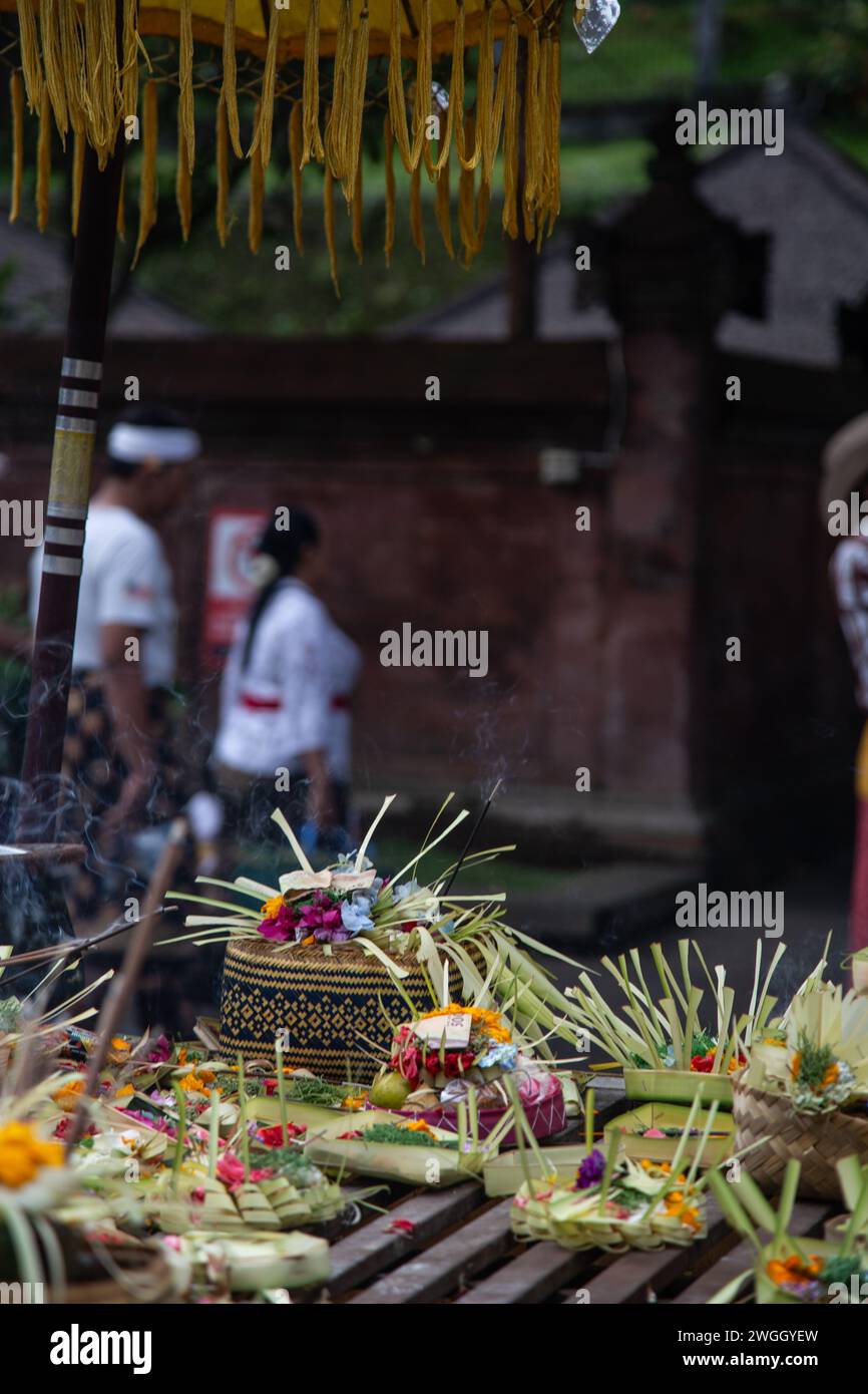 Offerings surrounded with incense at Balinese temple Stock Photo - Alamy