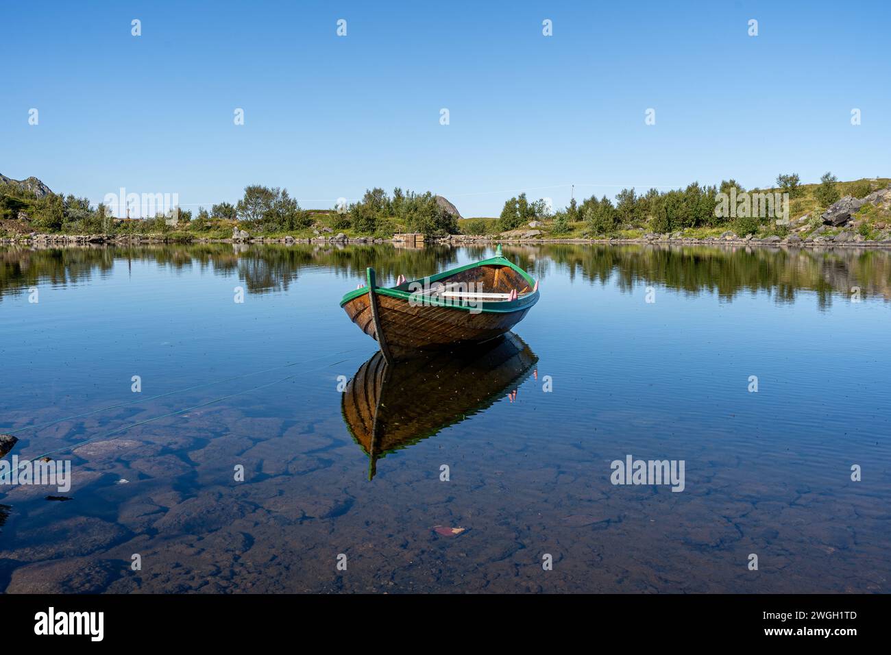 A Boat on tranquil lake water in Bleik Andoya, Norway Stock Photo