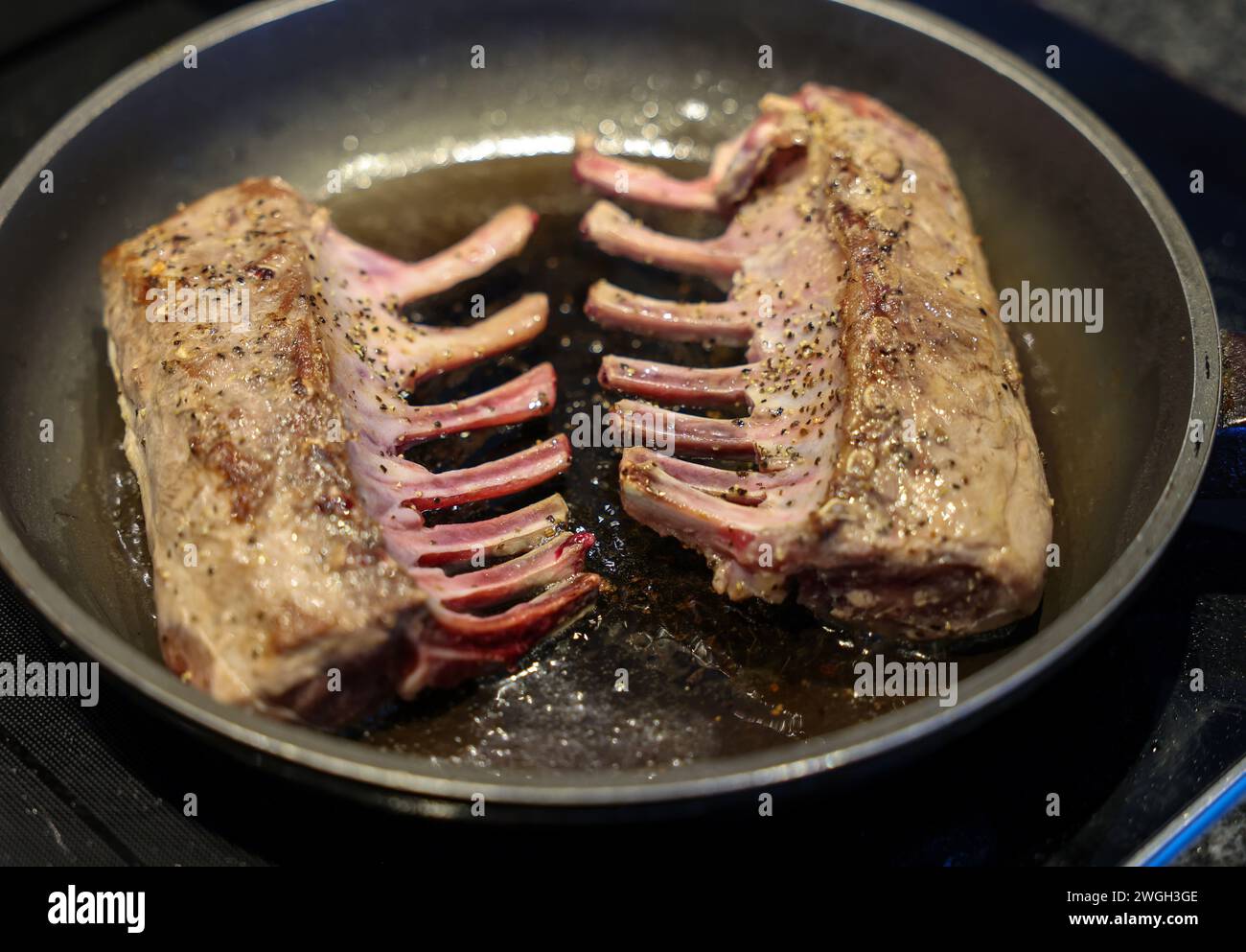 Spiced saddle of lamb grilled in a pan Stock Photo