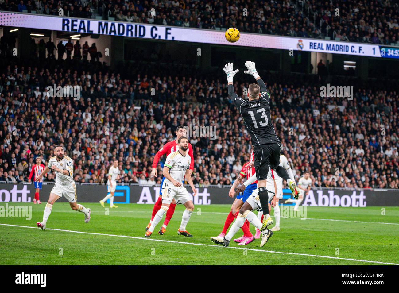 Madrid, Spain. 04th Feb, 2024. Andriy Lunin (R) of Real Madrid seen in action with the ball with his teammates Nacho Fernandez (C) and Daniel Carvajal (L) during the La Liga EA Sports 2023/24 football match between Real Madrid and Atletico Madrid at Santiago Bernabeu stadium. Final score; Real Madrid 1 : 1 Atletico Madrid. Credit: SOPA Images Limited/Alamy Live News Stock Photo