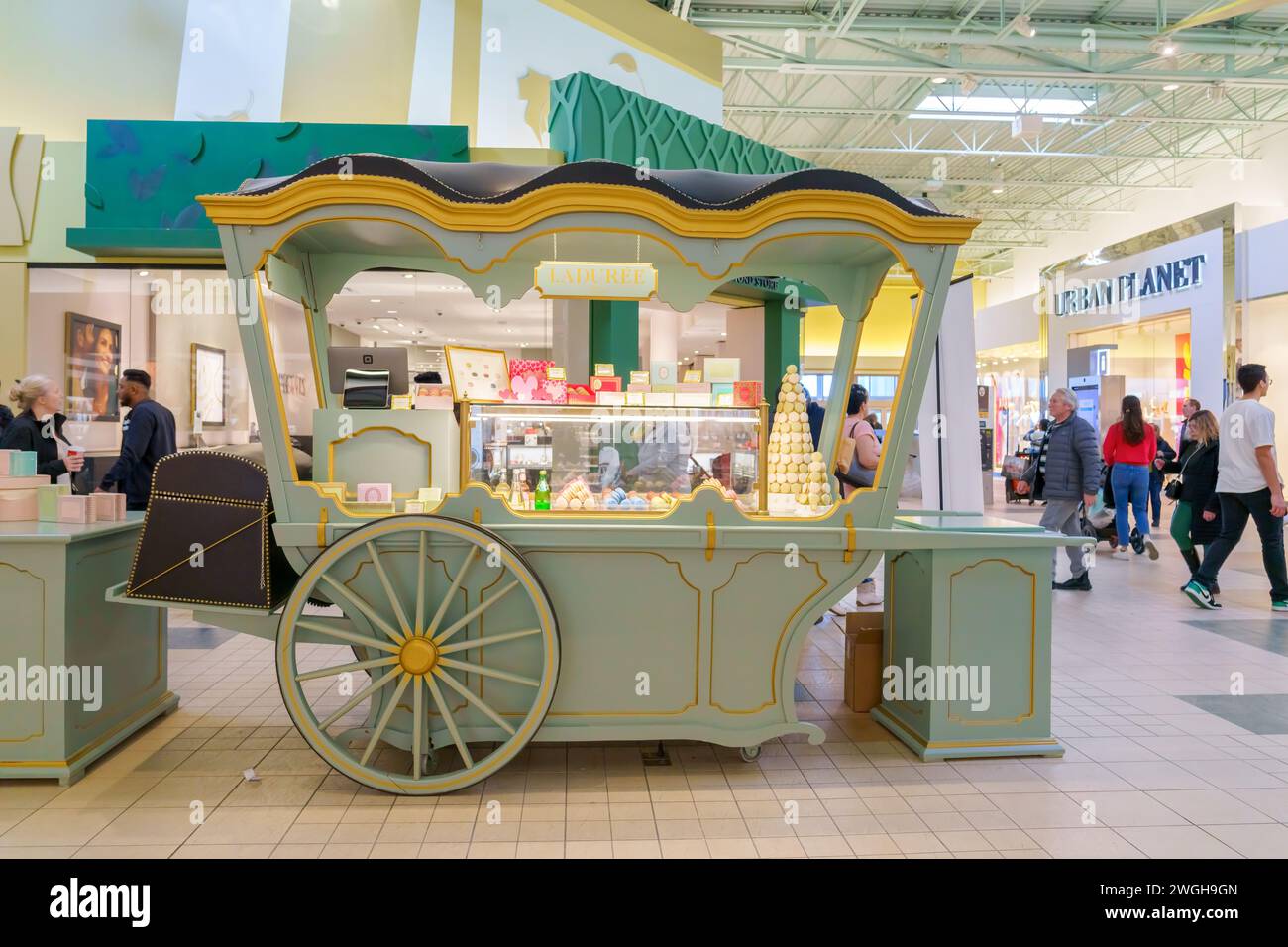 Kiosk with the shape of a cart in a corridor of the Vaughan Mills shopping center. The business is selling macarons. Stock Photo