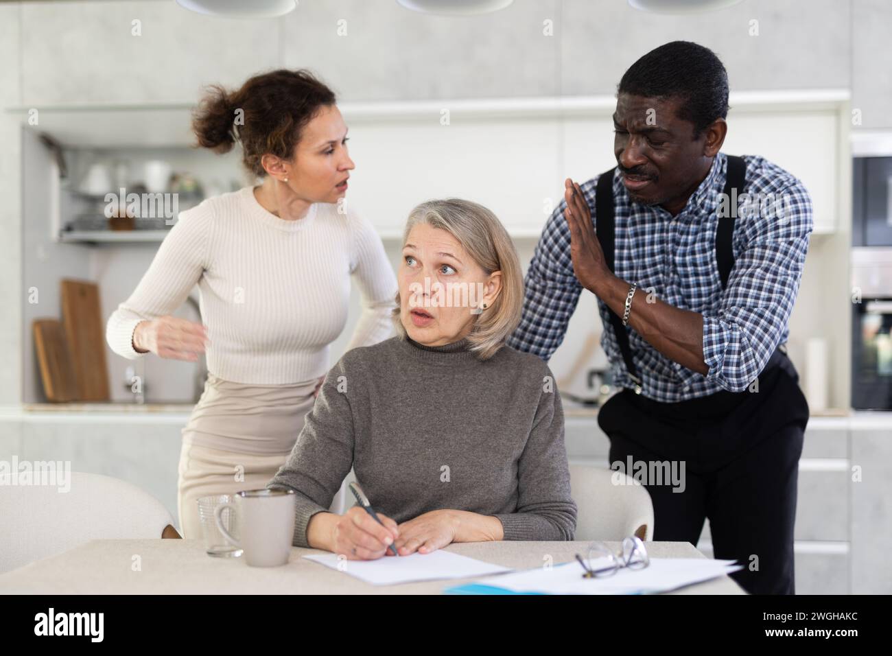 Couple discussing testament with elderly woman Stock Photo
