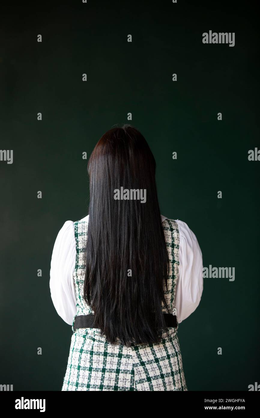 Rear view young woman with long black hair Stock Photo - Alamy