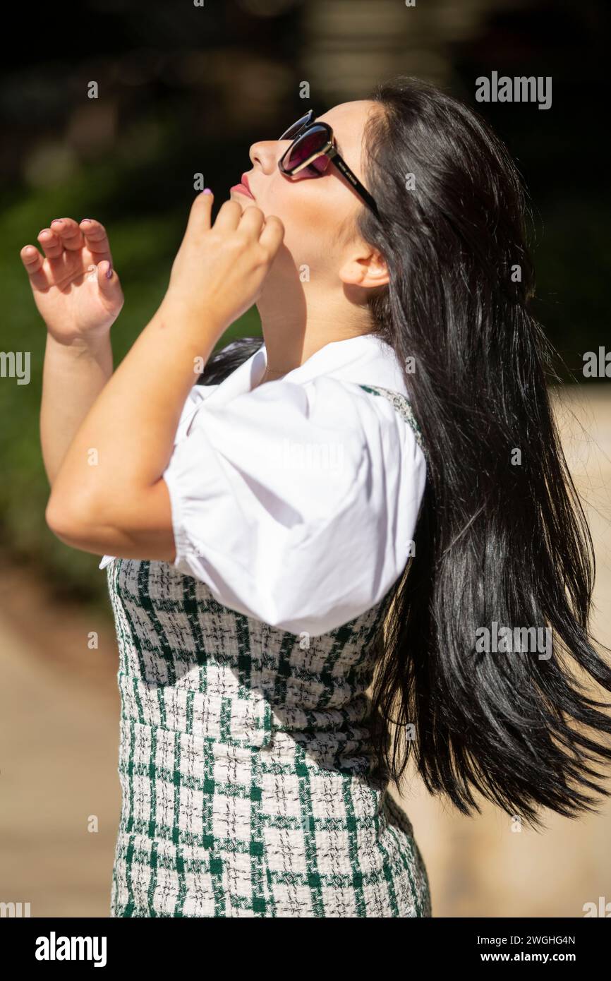 Beautiful young woman wearing sunglasses outdoors Stock Photo