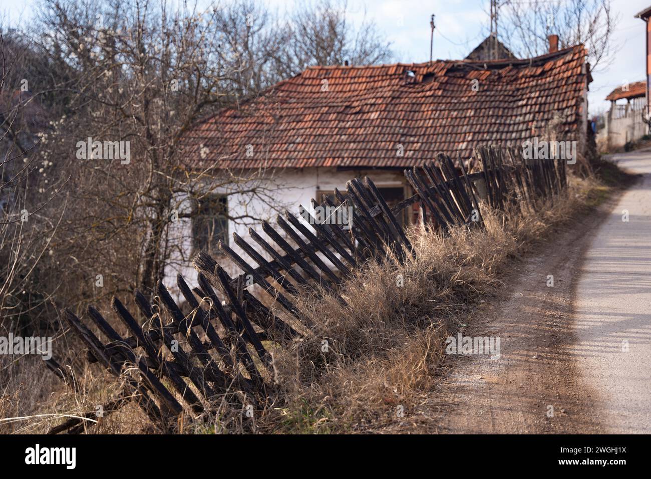Old dilapidated houses in an abandoned mountain Serbian village in southeastern Serbia, on the slopes of Suva Planina mountain. Stock Photo