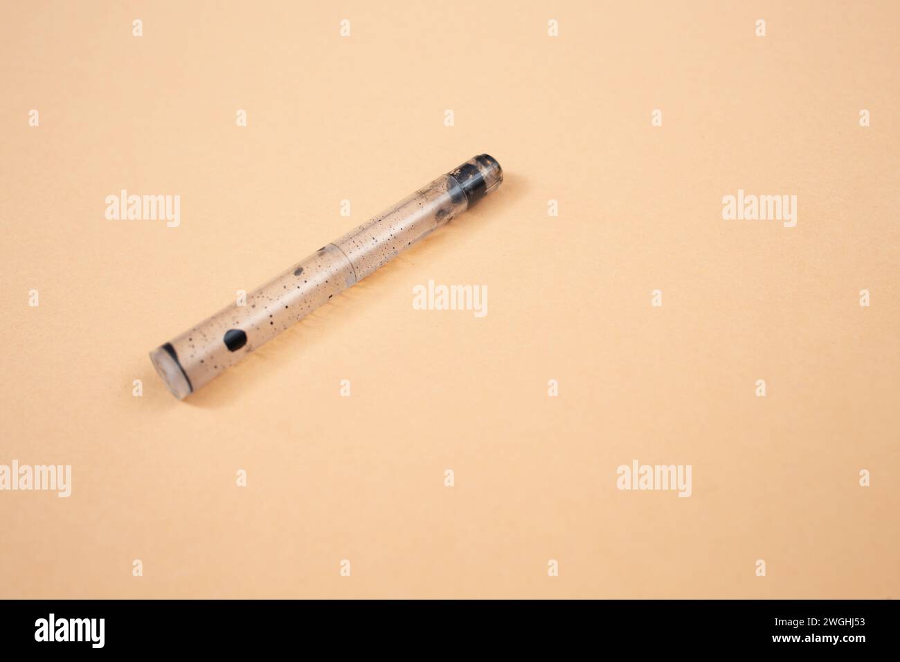 empty fountain pen cartridge , on beige background, close up Stock