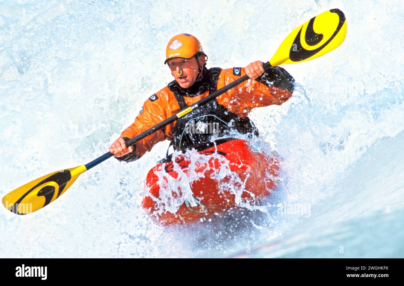 Kayaker in a wave of the Isar at the Wittelsbacher Bridge, Munich, Germany Stock Photo