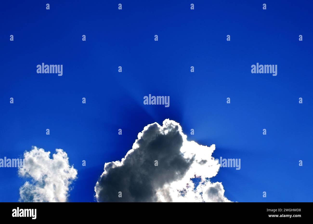 the sun hides behind a spring cloud Stock Photo
