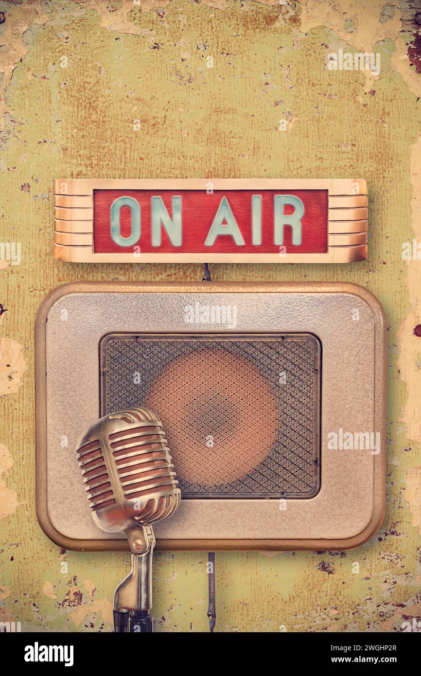 Retro styled image of an authentic vintage microphone with on air illuminated sign and speaker Stock Photo