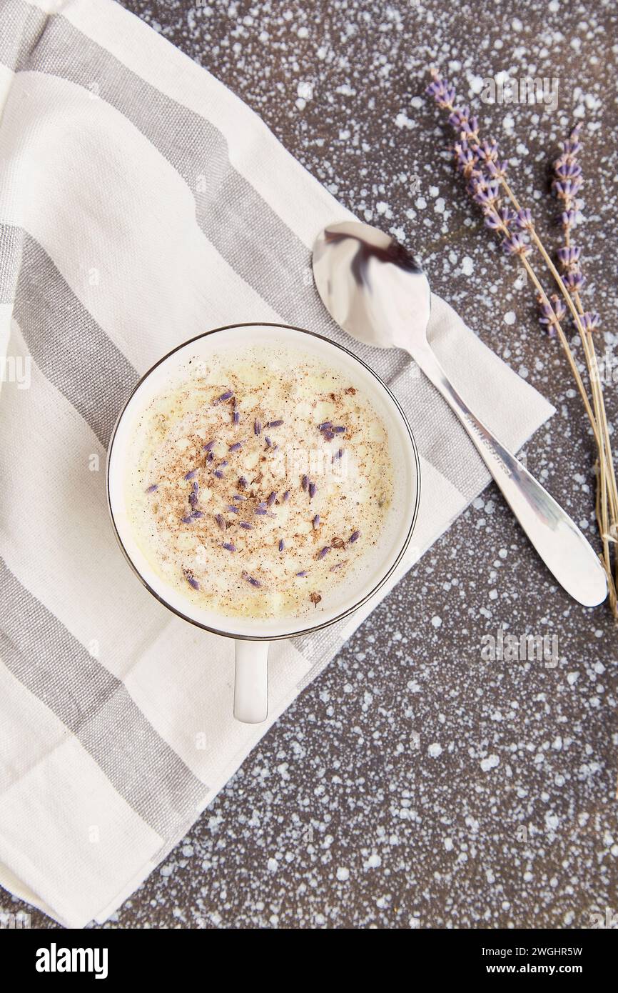 Aesthetic stylish lavender coffee with flowers flat lay. Stock Photo