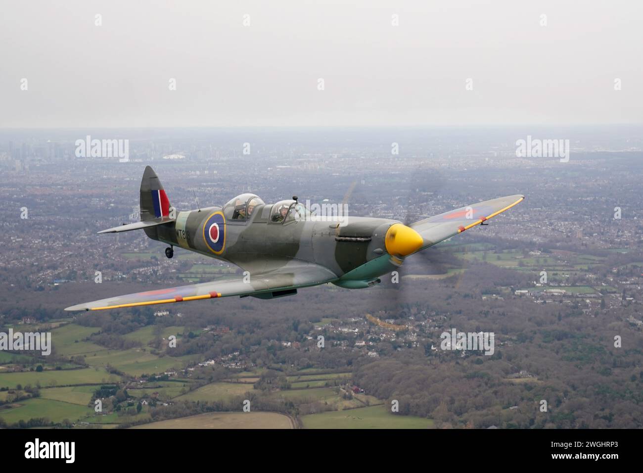 102-year-old Jack Hemmings AFC (left) flies a Spitfire plane to mark 80th anniversary of the military charity Mission Aviation Fellowship (MAF). The former RAF Squadron Leader and pioneer of MAF, the world's largest humanitarian air service, has become the oldest Briton to fly a spitfire. Mr Hemmings, who lives at home in Horam, Sussex, was given access to the iconic Heritage Hanger at London Biggin Hill, and took to the skies in Britain's best-loved Second World War aircraft to raise money for MAF, the charity he co-founded almost 80 years ago. Picture date: Monday February 5, 2024. Stock Photo