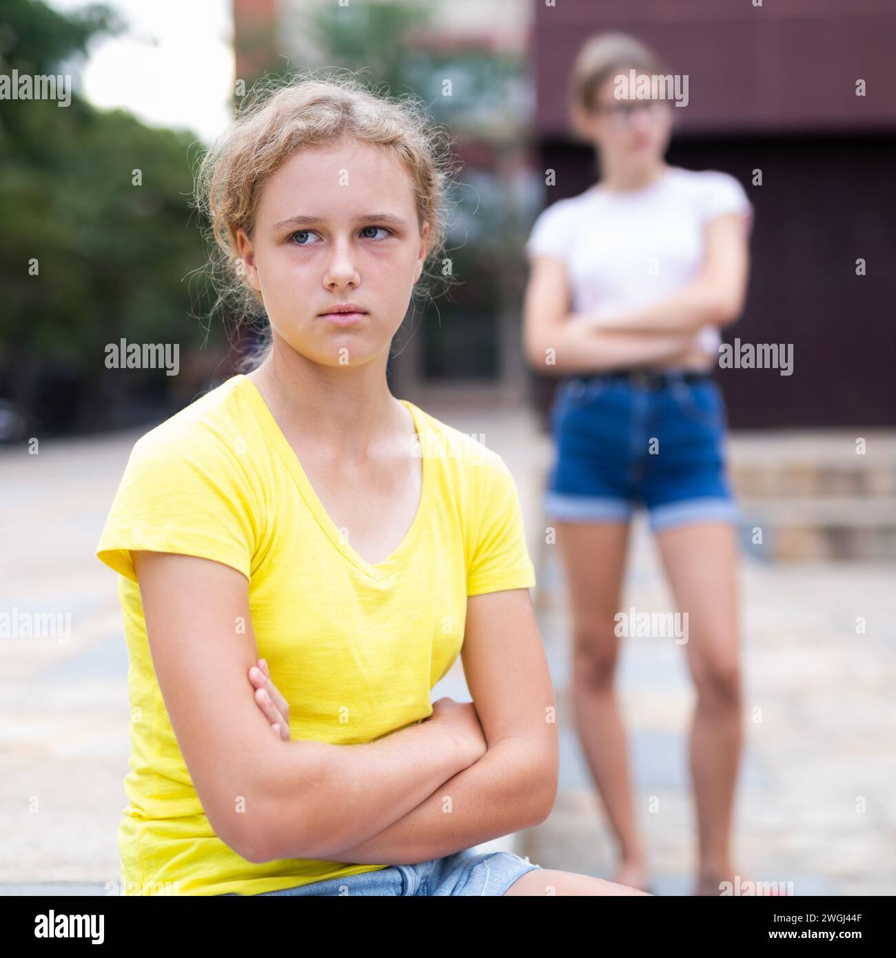 Two young girls having quarrel outdoors Stock Photo