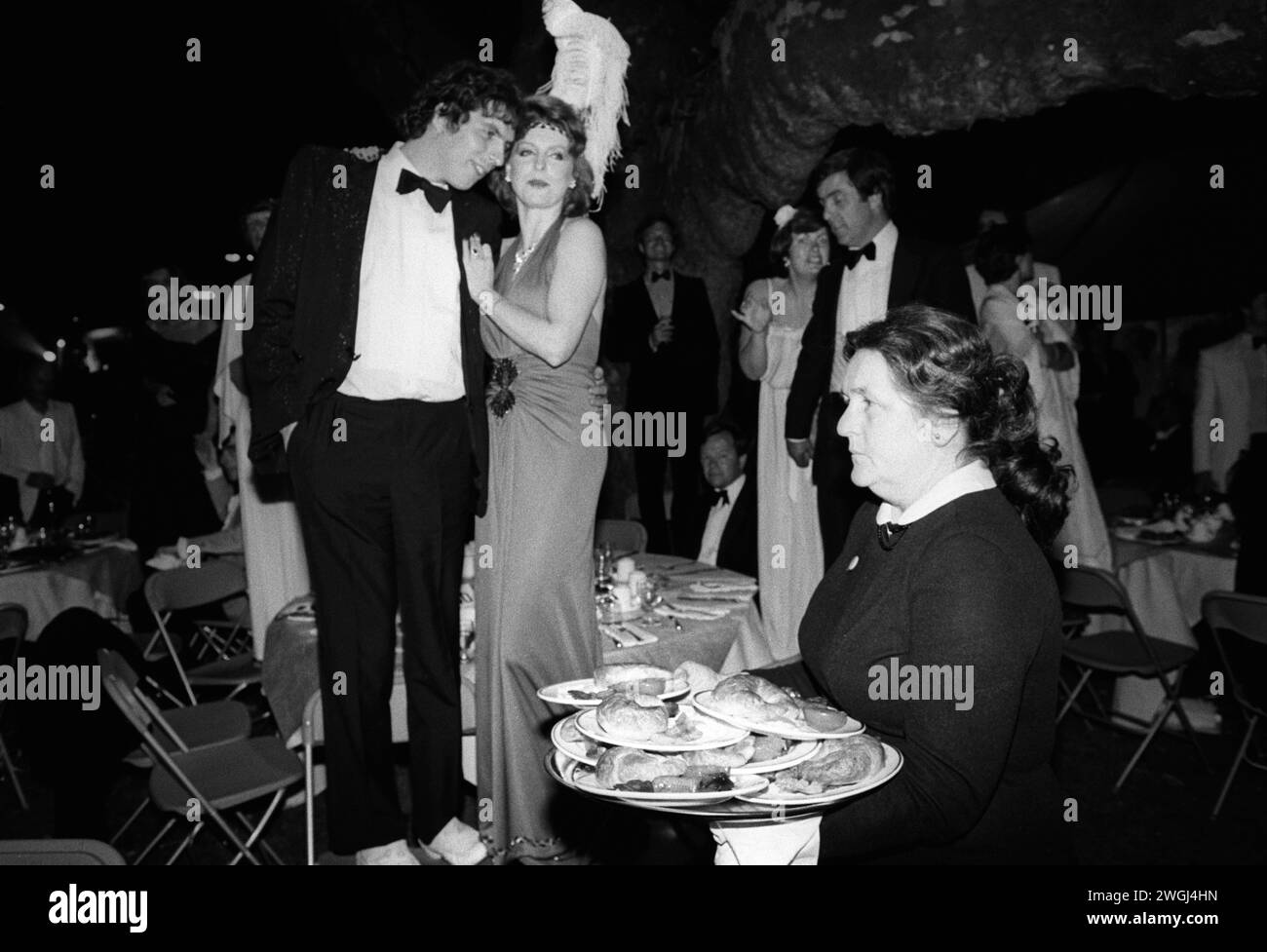 Part time work as a waitress low pay 1980s UK. Wealthy middle class enjoy an end of summer alfresco meal at the annual Berkeley Square Ball in London. Westminster, London, England circa September 1981 HOMER SYKES Stock Photo