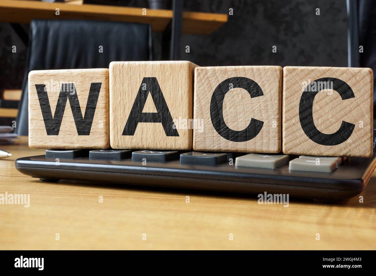 WACC Weighted Average Cost of Capital concept. Wooden cubes on a calculator. Stock Photo