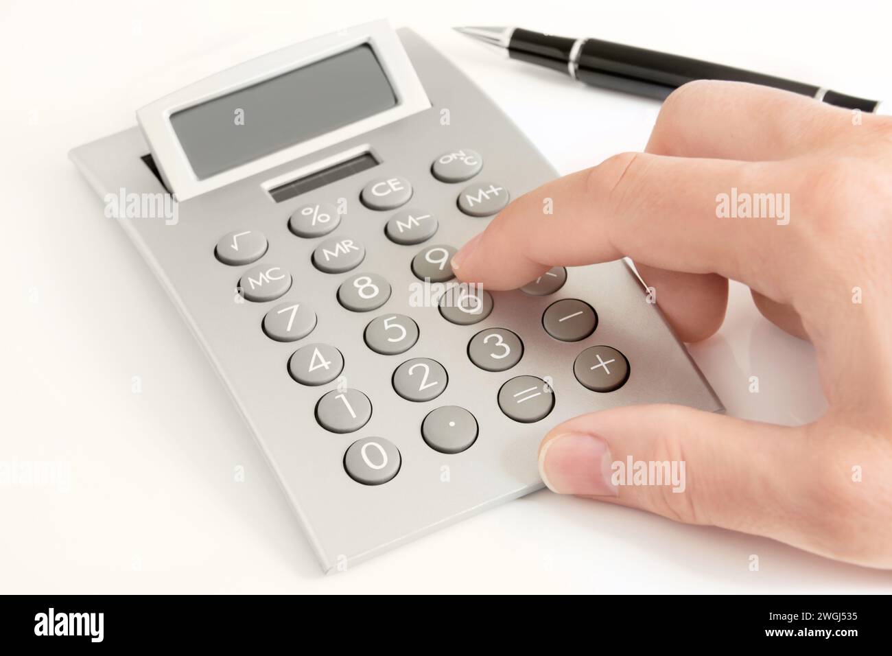 Male hand and calculator on white background Stock Photo