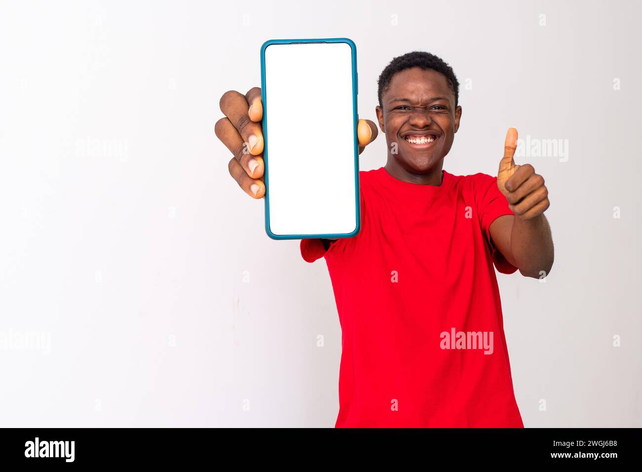 excited young back man shows blank, large phone screen Stock Photo