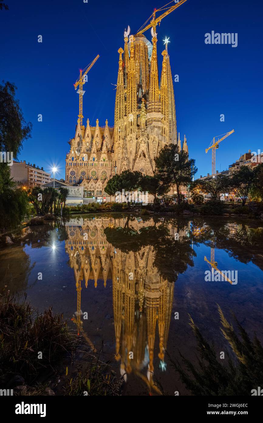 The famous Sagrada Familia in Barcelona at night reflected in a small pond Stock Photo