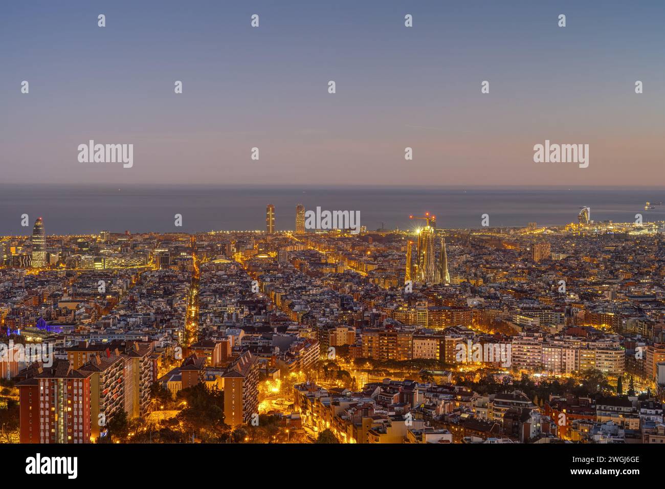 The skyline of Barcelona with the Sagrada Familia and the other iconic Skyscrapers at twilight Stock Photo