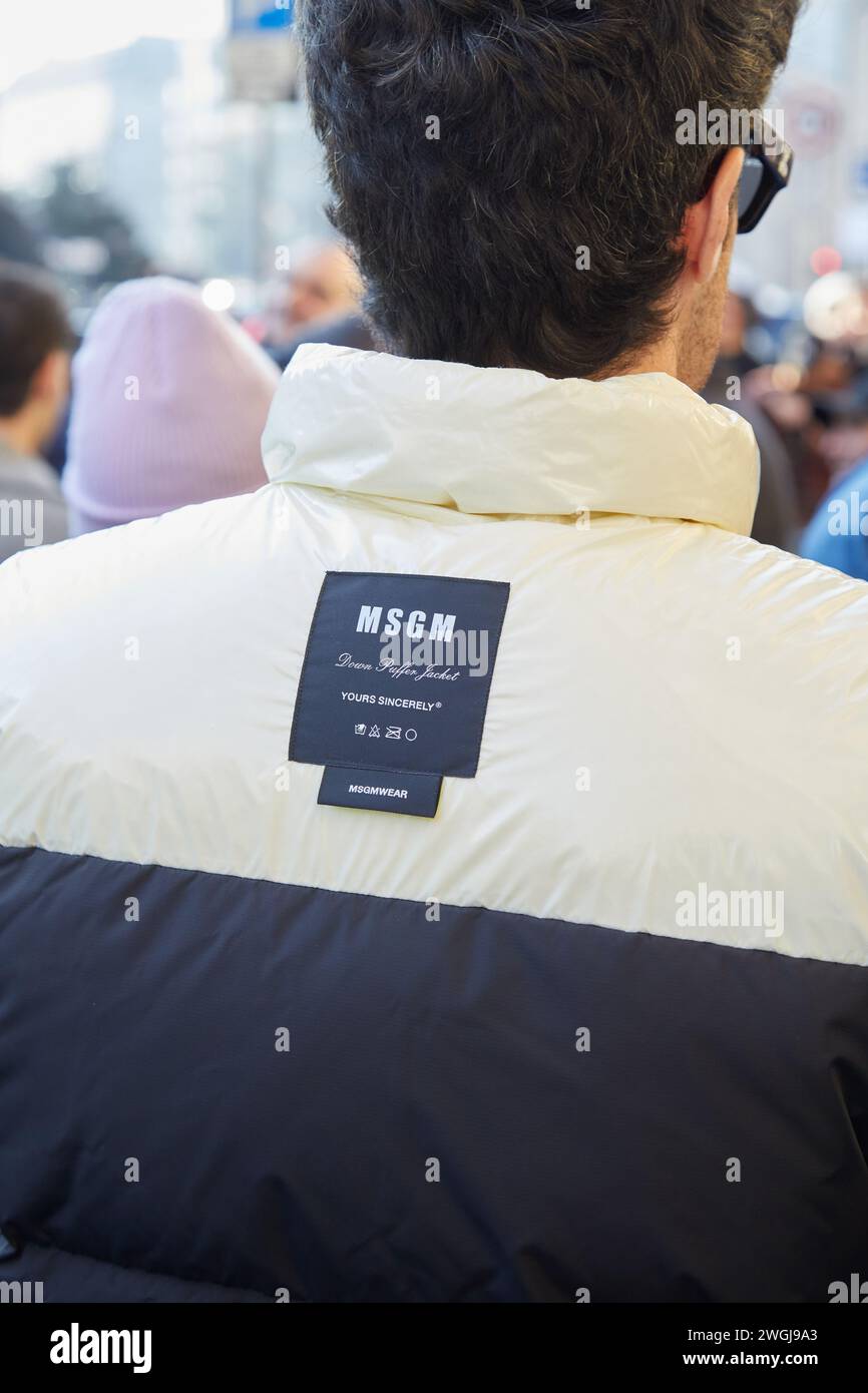 MILAN, ITALY - JANUARY 13, 2024: Man with MSGM white and blue puffer jacket before MSGM fashion show, Milan Fashion Week street style Stock Photo