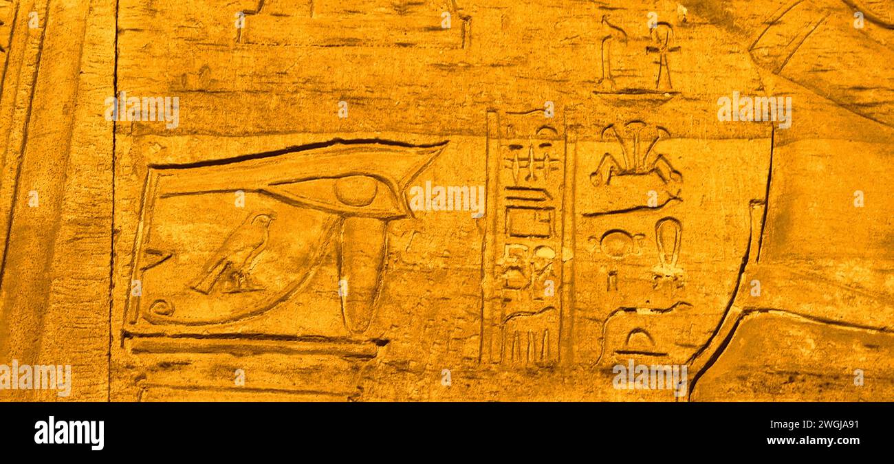 An Egyptian wall with carvings resembling pharaohs Stock Photo