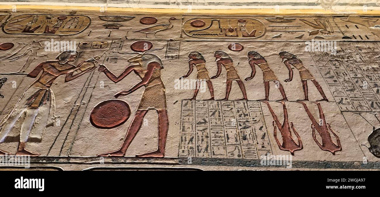 An ancient Egyptian paintings adorn the walls of a historic structure Stock Photo