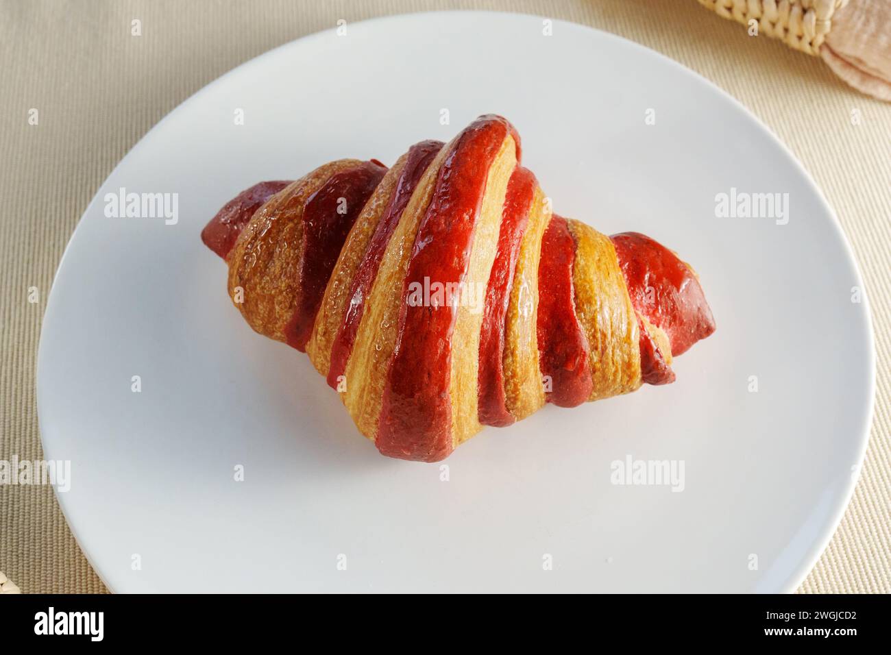 White Porcelain Platter, Adorned With a Juicy Croissant Crimson Strawberry. Stock Photo